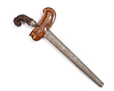 A SILVER INDONESIAN KRIS, 19TH CENTURY. With a finely carved wooden hilt, a distinctive 