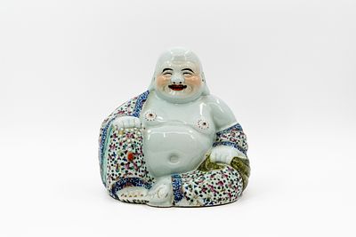 A Chinese Famille rose decorated porcelain figure of seated buddha. A Chinese famille rose 