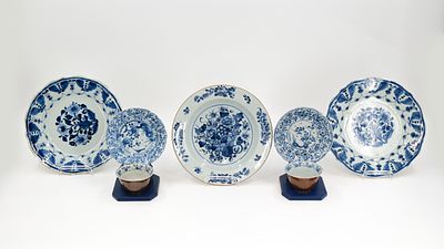 A lot of three Chinese blue and white flora decorated plates, and two small cups and underplates. 