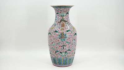 A Chinese Famille rose lotus scroll decorated porcelain vase on a pink background and a 