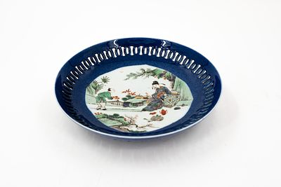 A Chinese Famille verte decorated and openwork blue poudre dish with the decor of an immortal 