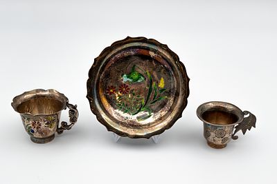 A three part Chinese decorated silver and enamel drinking set. Consisting of two small cups and 