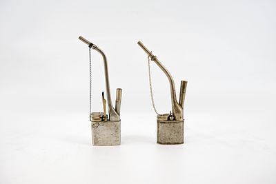 A lot of two Chinese Paktong engraved brass opium pipes. 20th century. H: 27,5 - 29 cm