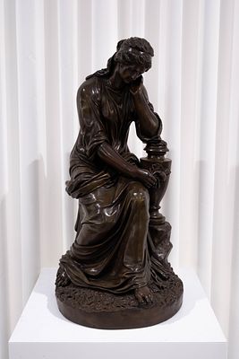 An imposing antique patinated galvano bronze sculpture depicting a resting sitting lady. 