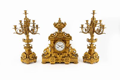 An imposing and large Parisian finely decorated gilt bronze Louis XVI style mantel clock set. An 