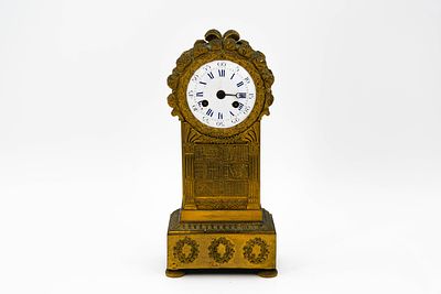 A French Empire gilt bronze mantel clock in the shape of a library with books. First half 19th 