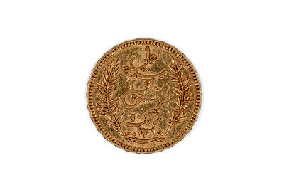 A Tunisian gold 20 Francs coin, dated 1900. With Arabic inscription within wreath on the 