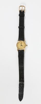 14K GOLD GENEVE LADIES' WATCH. Yellow gold with leather band; leather band has damage; not 