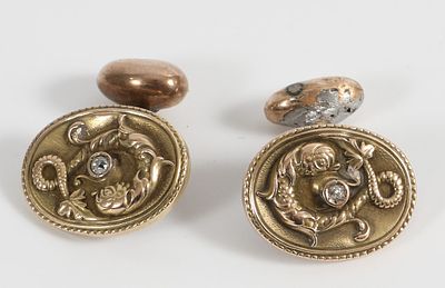 YELLOW GOLD SEA SERPENT CUFFLINKS. 14K yellow gold, mark partially obliterated from wear; oval 