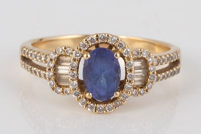 14K BLUE STONE RING WITH ACCENT DIAMONDS. 14K yellow gold ring set with central pale blue 