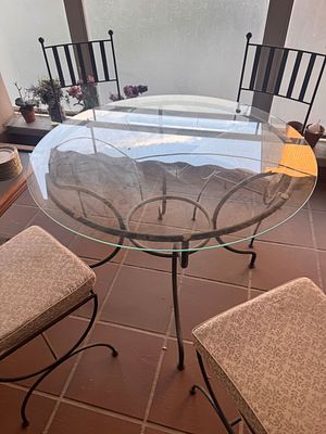 Wrought Iron and Glass Dining Set. An elegant set consisting of a round table and matching 