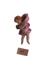 Miniature decorative figurine of a little angel. Charming small decorative figurine in a classic 