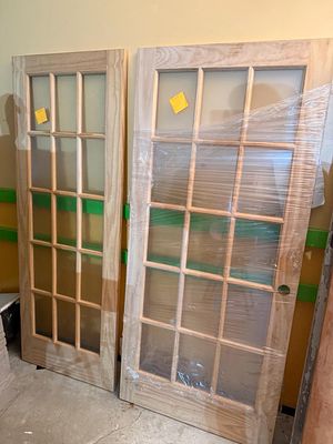 Two Unfinished Wood 15-Lite Interior French Doors. This lot features two interior French doors 