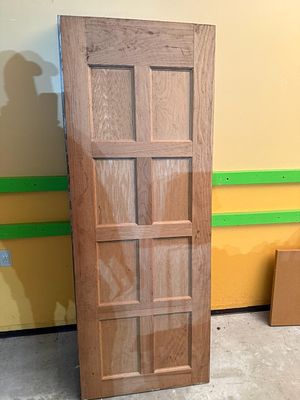 Reclaimed Eight-Panel Solid Oak Door Slab. A reclaimed solid wood door, likely oak, featuring a 