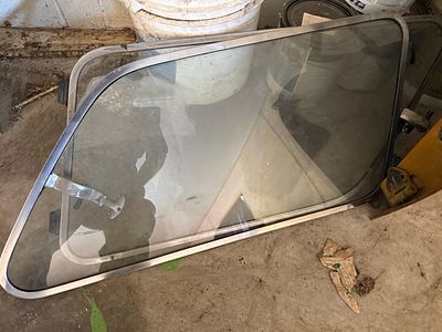 A Pair of Vintage Automotive Pop-Out Rear Quarter Windows Attributed to Austin America. This lot 