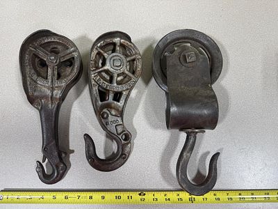A Trio of Antique Cast Iron Hay Trolley Pulleys including F.E. Myers and Goshen Manufacturing Co. 