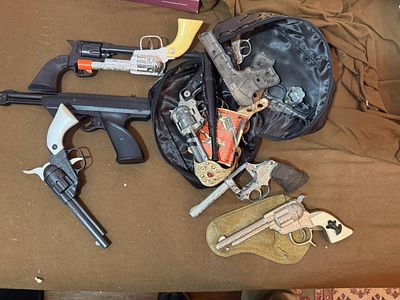 An Assortment of Vintage Toy Cap Guns including Hopalong Cassidy and a Daisy 188 Air Pistol. This 