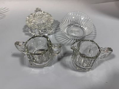 An Assortment of Clear Pressed Glass Tableware Including a Creamer and Sugar Set in the Style 