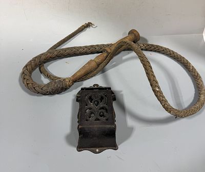 Two Vintage Items including a Braided Leather Bullwhip and a Cast Iron Wall-Mounted Match Holder