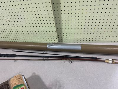 Two Disassembled Fishing Rods and a Protective Transport Tube
