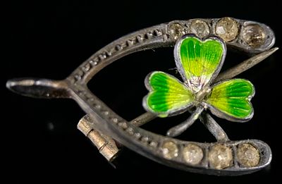 Antique 900 Silver Horseshoe Brooch with Enamel Shamrock. An antique or vintage brooch crafted 