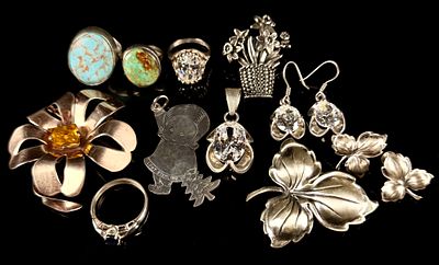 A Collection of Vintage Sterling Silver Jewelry, including Rings, Pendants, and Brooches 2.5 Ozt. 