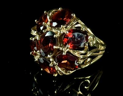 10K Yellow Gold Cluster Ring Set with Faceted Red Garnets. A single 10-karat yellow gold cluster 