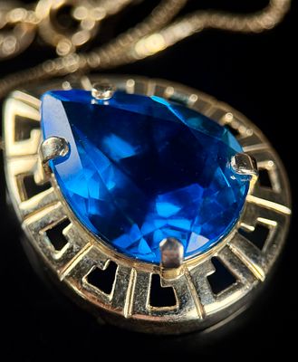 14K Gold Box Chain Necklace with Pear-Cut Blue Simulant Pendant. A contemporary necklace 