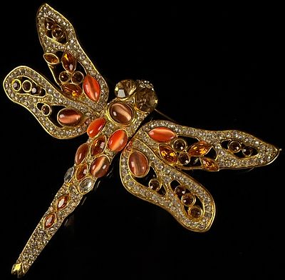 A Gold-Tone and Multi-Stone Dragonfly Brooch. This dragonfly brooch is constructed from 