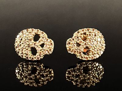 A Pair of 14k Yellow Gold and Pave-Set Stone Skull Stud Earrings. A pair of skull-motif stud 