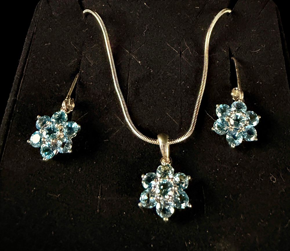A Trio of Sterling Silver and Blue Topaz Floral Cluster Jewelry Items. A sterling silver and 