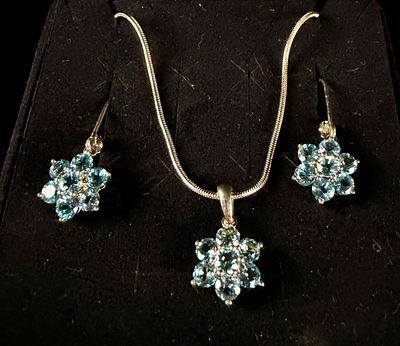 A Trio of Sterling Silver and Blue Topaz Floral Cluster Jewelry Items. A sterling silver and 