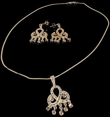 Sterling Silver and Cubic Zirconia Scroll Motif Jewelry Suite. A sterling silver jewelry suite 