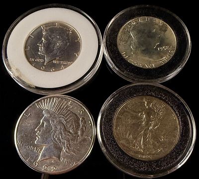 A Collection of US Silver Dollar and Half Dollar Coins. This collection of United States silver 