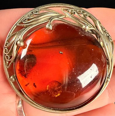 European .835 Silver and Baltic Amber Circular Openwork Brooch. A circular openwork brooch 