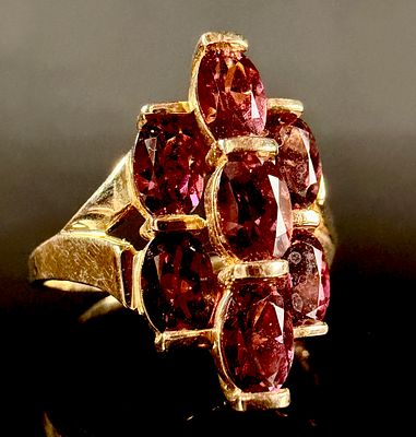 14K Yellow Gold Garnet Cluster Ring. 14 karat yellow gold ring featuring a cluster of oval-cut 