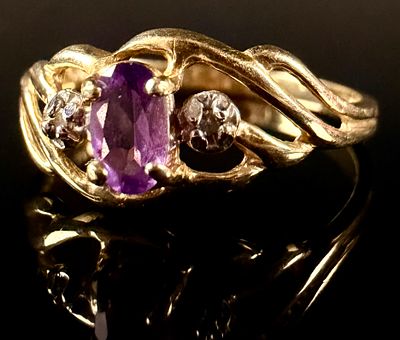 14 Karat Yellow Gold Amethyst and Diamond Bypass Ring. A 14 karat yellow gold fashion ring 
