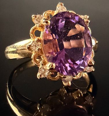 14 Karat Yellow Gold Amethyst and Diamond Cocktail Ring. This cocktail ring is crafted in 14 
