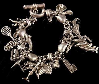 Vintage Sterling Silver Multi-Charm Toggle Bracelet with Red Gemstones. A substantial sterling 