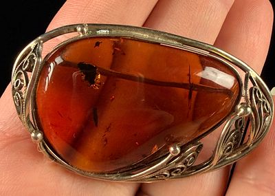 Baltic Amber and Sterling Silver Filigree Brooch. A large asymmetrical brooch featuring a 