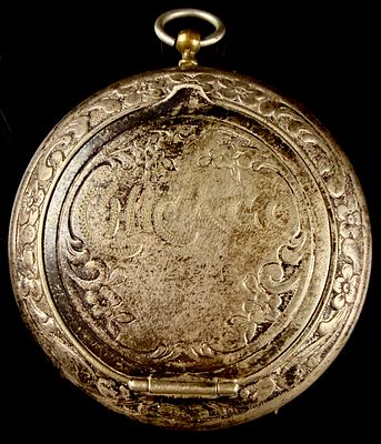 Antique German Silver Repousse Floral Pendant Case. An antique circular pendant case crafted 