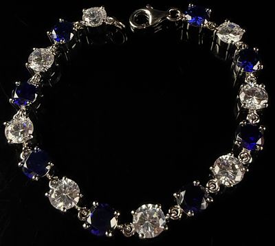 Sterling Silver Tennis Bracelet with Alternating Blue and Colorless Stones. This sterling silver 