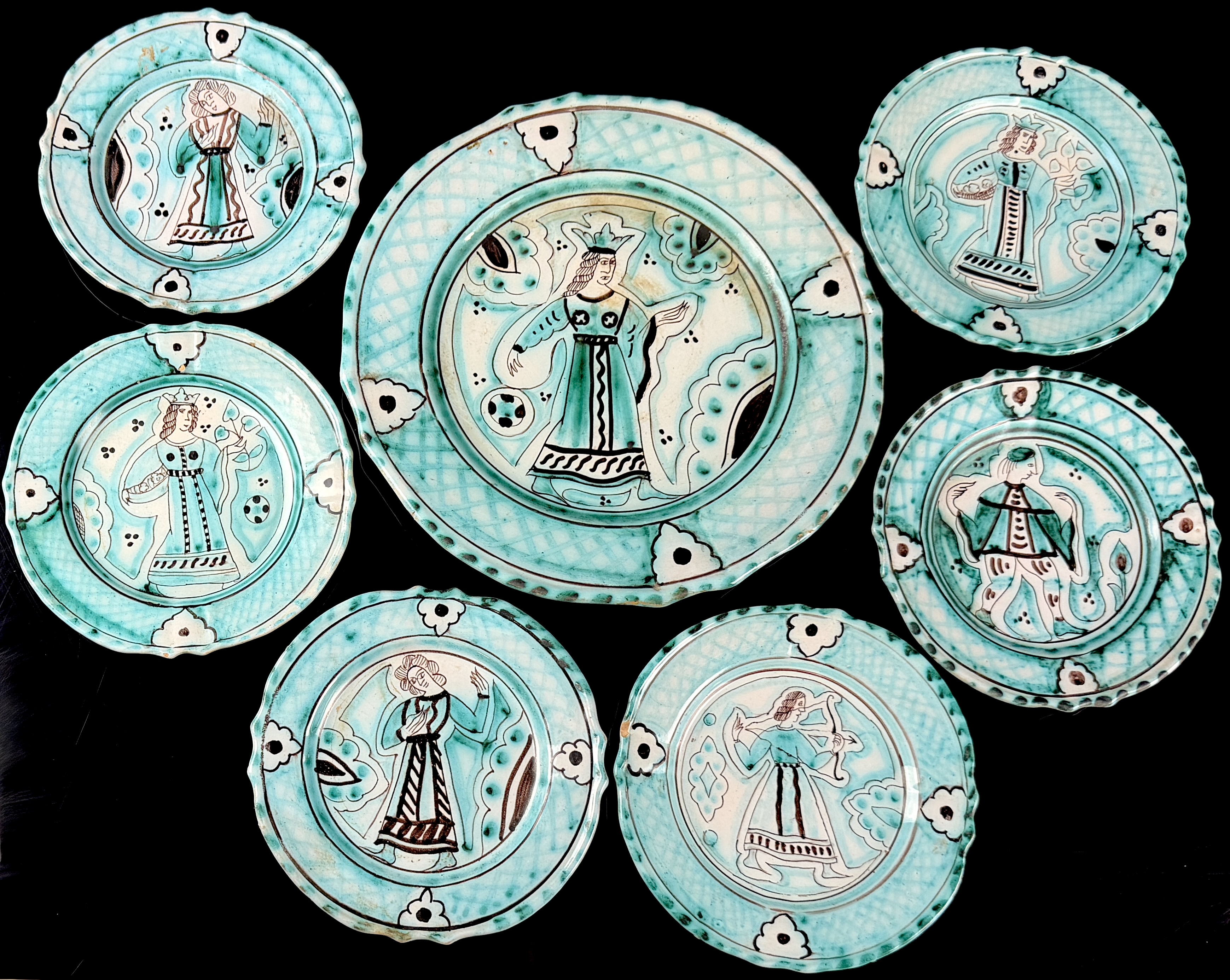 A Seven-Piece Set of Italian Hand-Painted Earthenware Plates in the Medieval Style