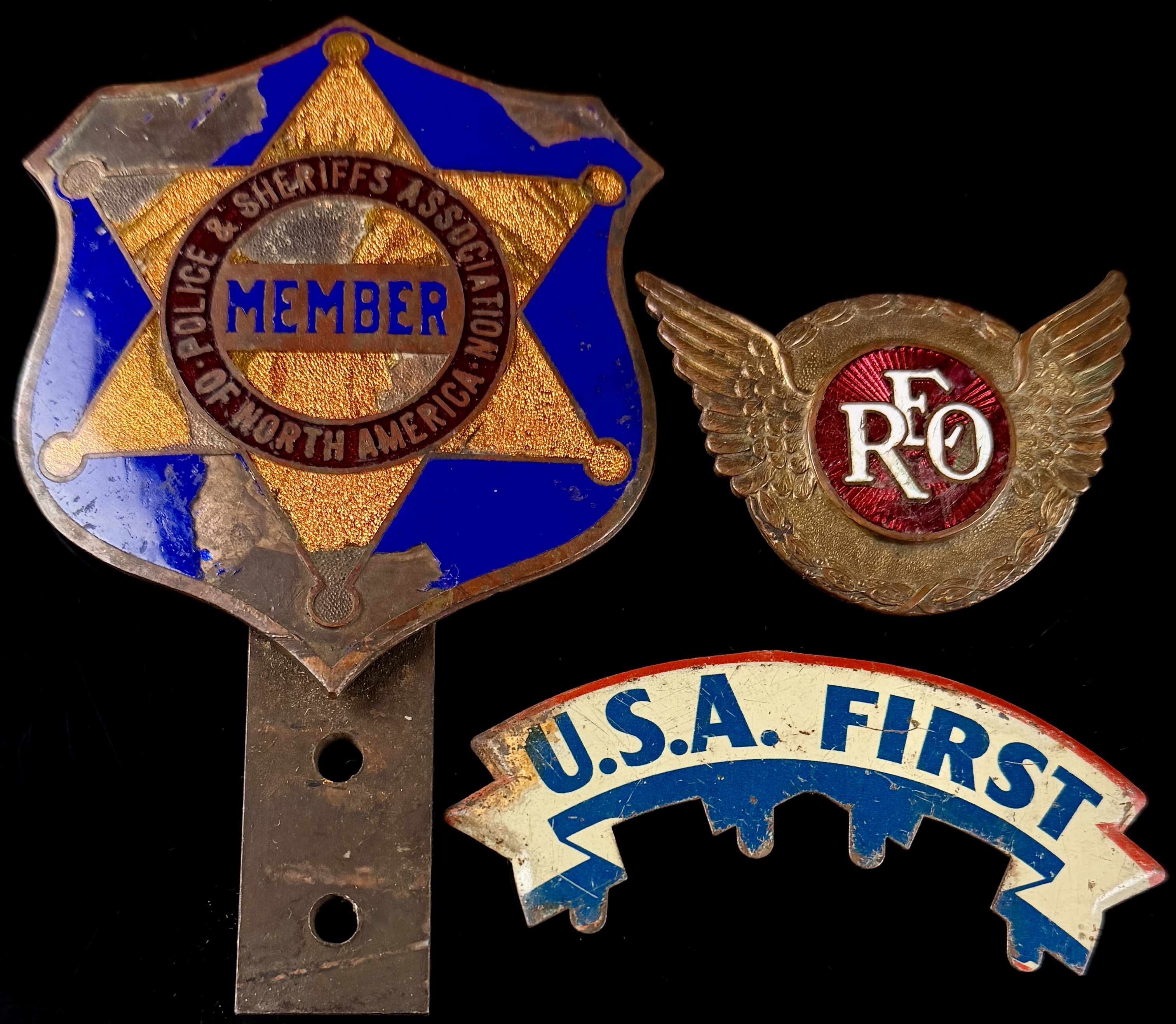 A Trio of Vintage Automotive Grille and Radiator Emblems including REO Motor Car Company