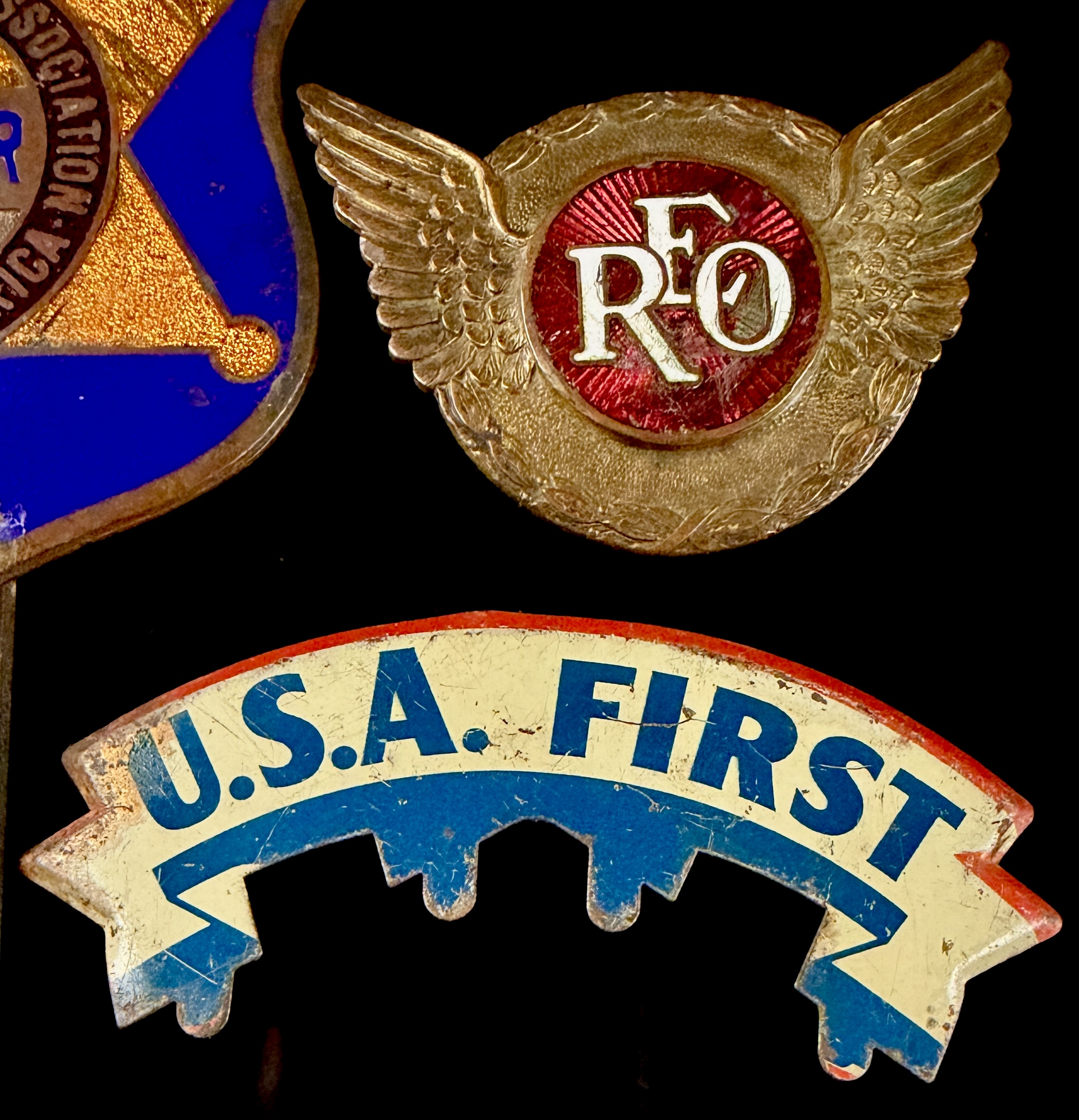 A Trio of Vintage Automotive Grille and Radiator Emblems including REO Motor Car Company