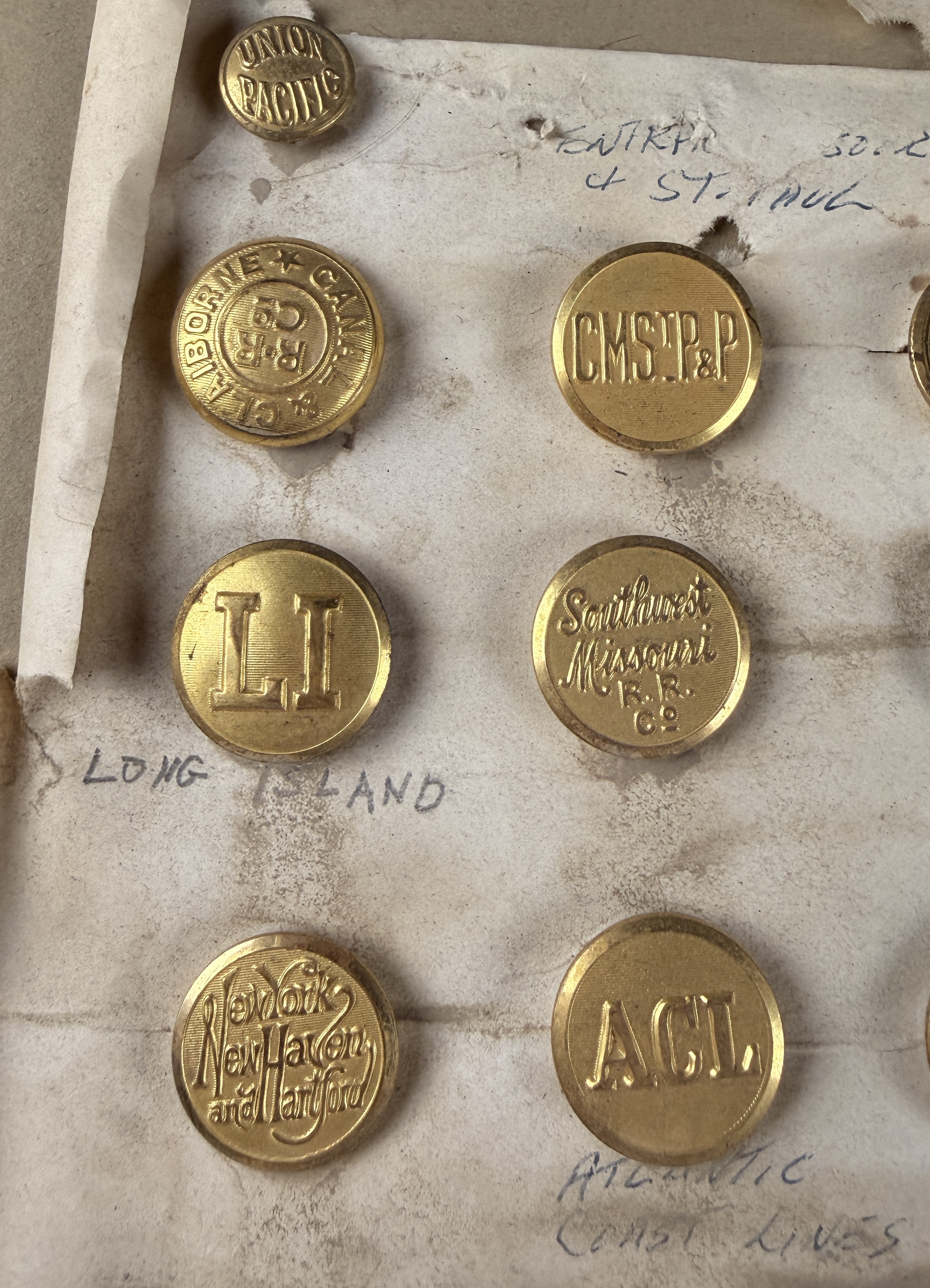 A Collection of 23 Vintage North American Railroad and Transit Uniform Buttons on Original Handwritten Mounting Card