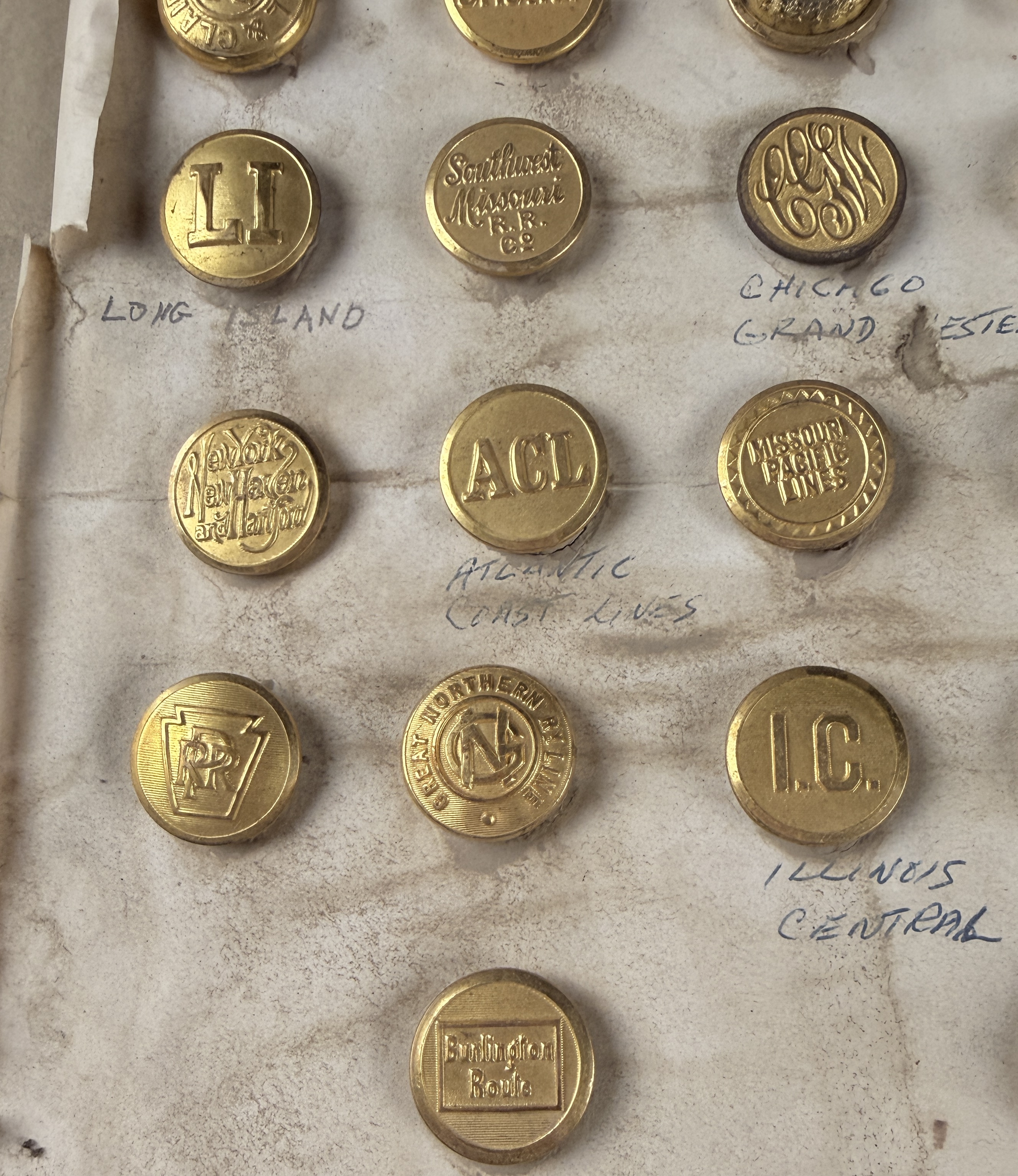 A Collection of 23 Vintage North American Railroad and Transit Uniform Buttons on Original Handwritten Mounting Card