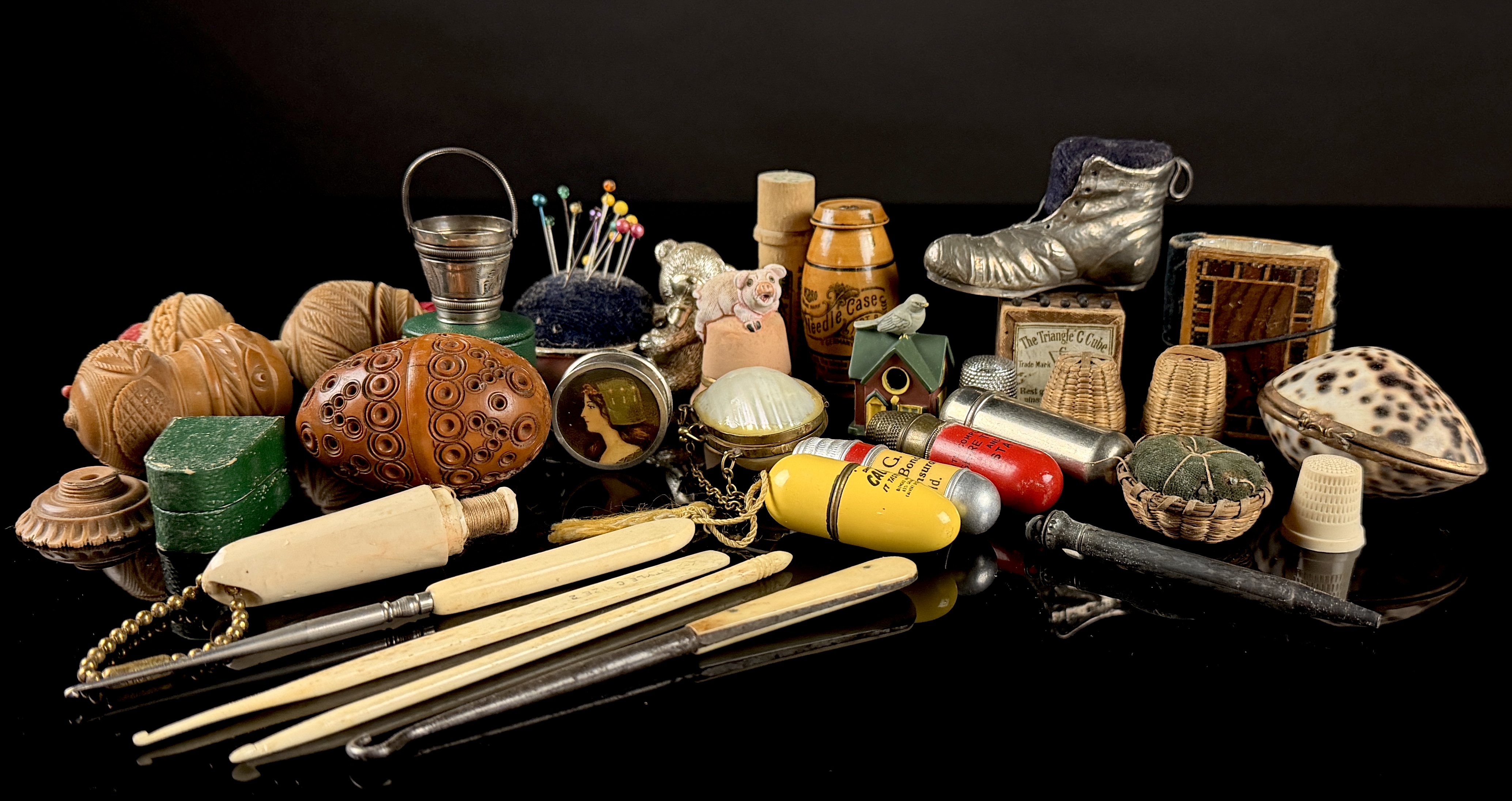 A Collection of Antique and Vintage Sewing Novelties, Tools, and Advertising Cases