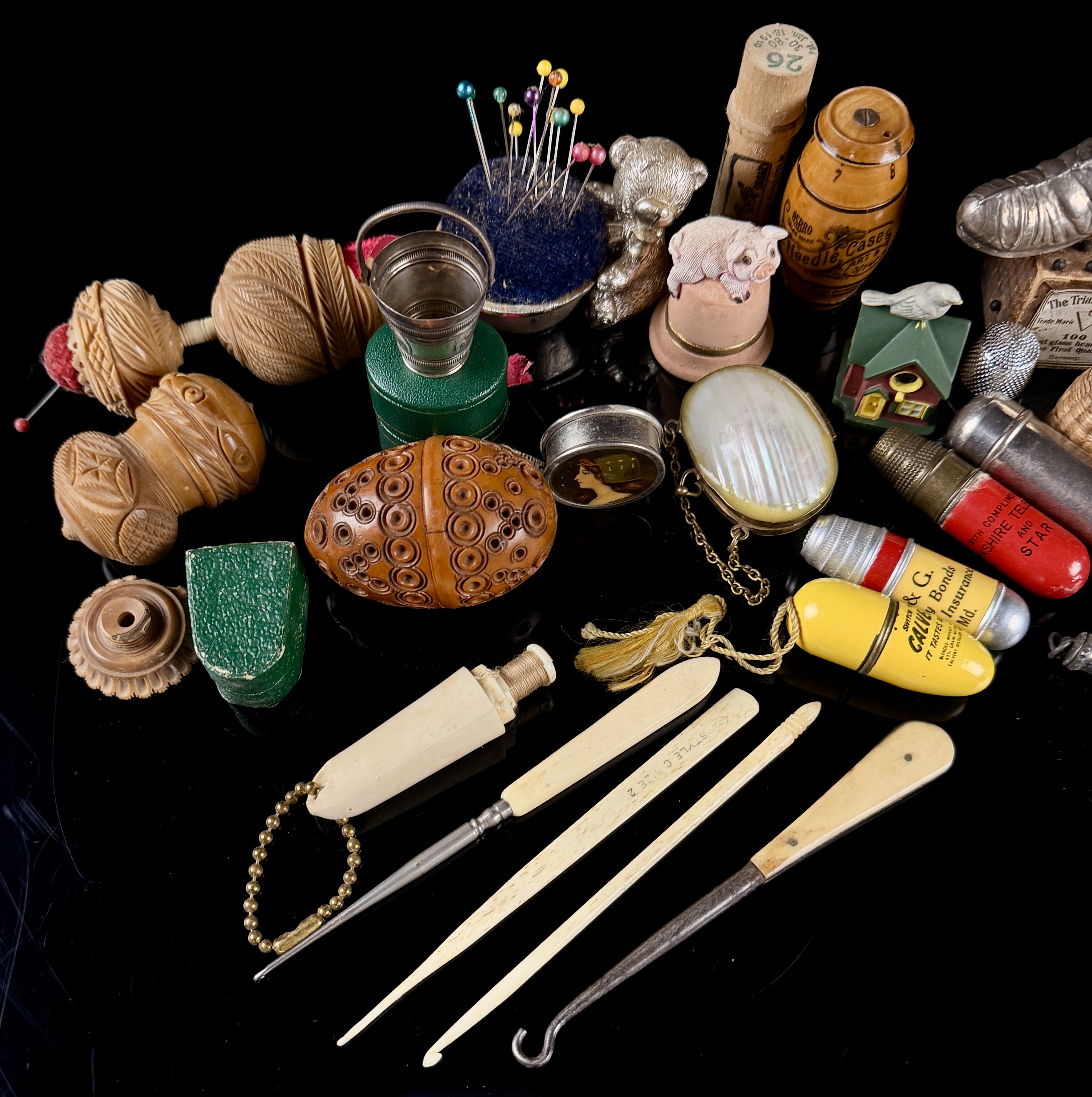 A Collection of Antique and Vintage Sewing Novelties, Tools, and Advertising Cases