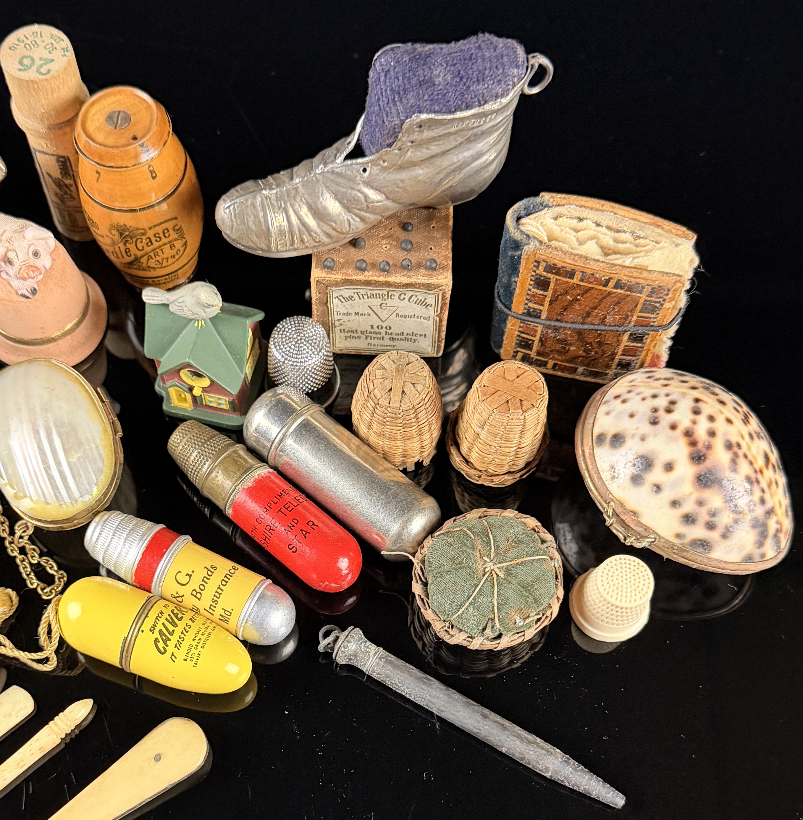 A Collection of Antique and Vintage Sewing Novelties, Tools, and Advertising Cases